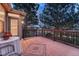 Deck area with wooden flooring, dark metal railings and outdoor table and chairs at 7454 Snow Lily Pl, Castle Pines, CO 80108