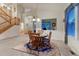 Inviting dining area with a wood table, chandelier, and lots of natural light at 7454 Snow Lily Pl, Castle Pines, CO 80108