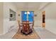 Charming dining area with a round wood table, rug, and abundant natural light at 7454 Snow Lily Pl, Castle Pines, CO 80108