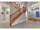Bright entryway features hardwood floors, a staircase, and a view into other rooms of the house at 7454 Snow Lily Pl, Castle Pines, CO 80108