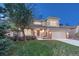 Lovely two-story home featuring a well-kept lawn, a two-car garage, and inviting curb appeal at 7454 Snow Lily Pl, Castle Pines, CO 80108