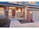 Charming front porch with brick accents, offering a welcoming entrance to this well-maintained home at 7454 Snow Lily Pl, Castle Pines, CO 80108