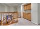 Upstairs hallway area with oak railing and built-in cabinets and drawers on the right at 7454 Snow Lily Pl, Castle Pines, CO 80108