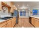 Bright kitchen and dining area boasts wooden cabinets, stainless steel appliances, and ample light at 7454 Snow Lily Pl, Castle Pines, CO 80108