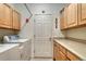 Well-organized laundry room with appliances and ample cabinet storage at 7454 Snow Lily Pl, Castle Pines, CO 80108