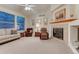 Cozy living room with lots of natural light, comfortable seating, and a fireplace at 7454 Snow Lily Pl, Castle Pines, CO 80108