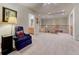 Cozy upstairs living area with comfortable seating, stairs, and access to a bathroom at 7454 Snow Lily Pl, Castle Pines, CO 80108