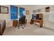 Cozy office space with natural light, featuring a desk, office chair, and carpeted flooring at 7454 Snow Lily Pl, Castle Pines, CO 80108