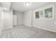 Finished basement with neutral carpet, bright window and white walls at 2319 Decatur St, Denver, CO 80211