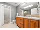 Bathroom with double sinks, tile flooring, skylight and separate shower and walk-in closet at 2319 Decatur St, Denver, CO 80211