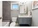 Bathroom featuring a gray vanity, tiled walls, and a shower-tub combination at 2319 Decatur St, Denver, CO 80211