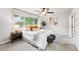 Bright bedroom featuring large window, ceiling fan, and trendy gray accent stools at 2319 Decatur St, Denver, CO 80211