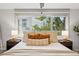 Bedroom featuring a large window, neutral tones, and a comfortable bed with decorative pillows at 2319 Decatur St, Denver, CO 80211