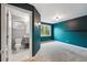 Bedroom featuring bright window, blue accent wall and an ensuite bathroom at 2319 Decatur St, Denver, CO 80211