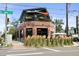 Street-level view of a brick brewery with outdoor seating, awnings, and lush landscaping at 2319 Decatur St, Denver, CO 80211