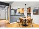 Dining area with modern light fixture, hardwood floors, and access to the kitchen at 2319 Decatur St, Denver, CO 80211