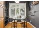 Bright dining area with natural light, a glass table, and seating for two with wood floors at 2319 Decatur St, Denver, CO 80211