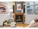 Cozy living area with a charming fireplace, accent chair, and stylish decor at 2319 Decatur St, Denver, CO 80211