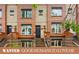 Charming brick townhome with a black door and well-manicured landscaping at 2319 Decatur St, Denver, CO 80211
