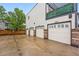 Row of garages with brick trim accents and white garage doors featuring the number 2319 at 2319 Decatur St, Denver, CO 80211