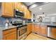 Well-lit kitchen with granite countertops, stainless steel appliances, and natural wood cabinets at 2319 Decatur St, Denver, CO 80211