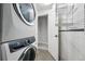 Laundry room featuring stacked washer and dryer, with shelving for storage at 2319 Decatur St, Denver, CO 80211