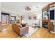 Bright, open-concept living space with hardwood floors and a cozy seating area at 2319 Decatur St, Denver, CO 80211