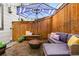 Private patio features a fire pit, comfortable seating, and an umbrella for shade, perfect for outdoor enjoyment at 2319 Decatur St, Denver, CO 80211