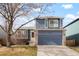 Charming two-story home with a blue exterior, brick accents, and a well-maintained front yard at 17623 Cornish Pl, Parker, CO 80134