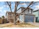 Charming two-story home with a blue exterior, brick accents, and a well-maintained front yard at 17623 Cornish Pl, Parker, CO 80134