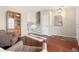 Inviting living room with hardwood floors, stylish furniture, and a charming display cabinet at 17623 Cornish Pl, Parker, CO 80134