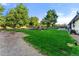 Expansive backyard featuring lush greenery, a playground, and an outdoor seating area at 1920 S Niagara St, Denver, CO 80224