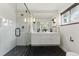 Modern bathroom features a glass-enclosed shower, double sink vanity, and stylish black and white design at 1920 S Niagara St, Denver, CO 80224