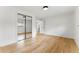Bright bedroom with hardwood floors, white walls, and a large closet with mirrored sliding doors at 1920 S Niagara St, Denver, CO 80224