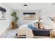 Well-lit bedroom with a unique chair and decor, featuring a comfortable bed and natural light at 1920 S Niagara St, Denver, CO 80224
