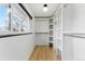 Well-organized walk-in closet with custom shelving and ample natural light, perfect for storage solutions at 1920 S Niagara St, Denver, CO 80224