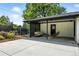 Cozy covered patio with a lovely seating area and view of the manicured lawn and landscaped garden at 1920 S Niagara St, Denver, CO 80224