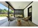 Relaxing covered patio with stylish seating, a center table and views of the landscaped yard at 1920 S Niagara St, Denver, CO 80224