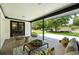 Comfortable covered patio with cozy seating, an accent table and an expansive yard at 1920 S Niagara St, Denver, CO 80224