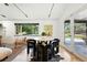 Chic dining area with a marble table, modern chairs, and views of the lush outdoor space at 1920 S Niagara St, Denver, CO 80224