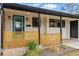 Welcoming front porch with a vibrant blue door, stylish wood slat railing, and modern outdoor lighting at 1920 S Niagara St, Denver, CO 80224