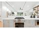 Modern kitchen featuring white countertops, stainless steel appliances, and open living space at 1920 S Niagara St, Denver, CO 80224