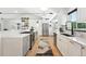 Spacious kitchen featuring white countertops, stainless steel appliances, and modern decor accents at 1920 S Niagara St, Denver, CO 80224