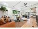Stylish living room with hardwood floors, neutral rug, and a large window offering a scenic backyard view at 1920 S Niagara St, Denver, CO 80224
