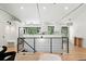 Open-concept living room with modern railing, wood floors, and a bright, airy atmosphere at 1920 S Niagara St, Denver, CO 80224