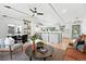 Bright, open-concept living space with vaulted ceilings, modern furnishings, and seamless flow to kitchen at 1920 S Niagara St, Denver, CO 80224