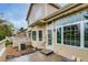 Back of the home featuring a patio with steps, an awning, and large windows at 3179 S Indiana St, Lakewood, CO 80228