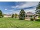 Expansive backyard offers lush lawn, mature trees, and serene views at 3179 S Indiana St, Lakewood, CO 80228