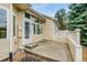 Back of the home featuring a patio with steps and a white fence at 3179 S Indiana St, Lakewood, CO 80228