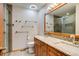 Well-lit bathroom with double sinks, granite counters, and modern fixtures at 3179 S Indiana St, Lakewood, CO 80228